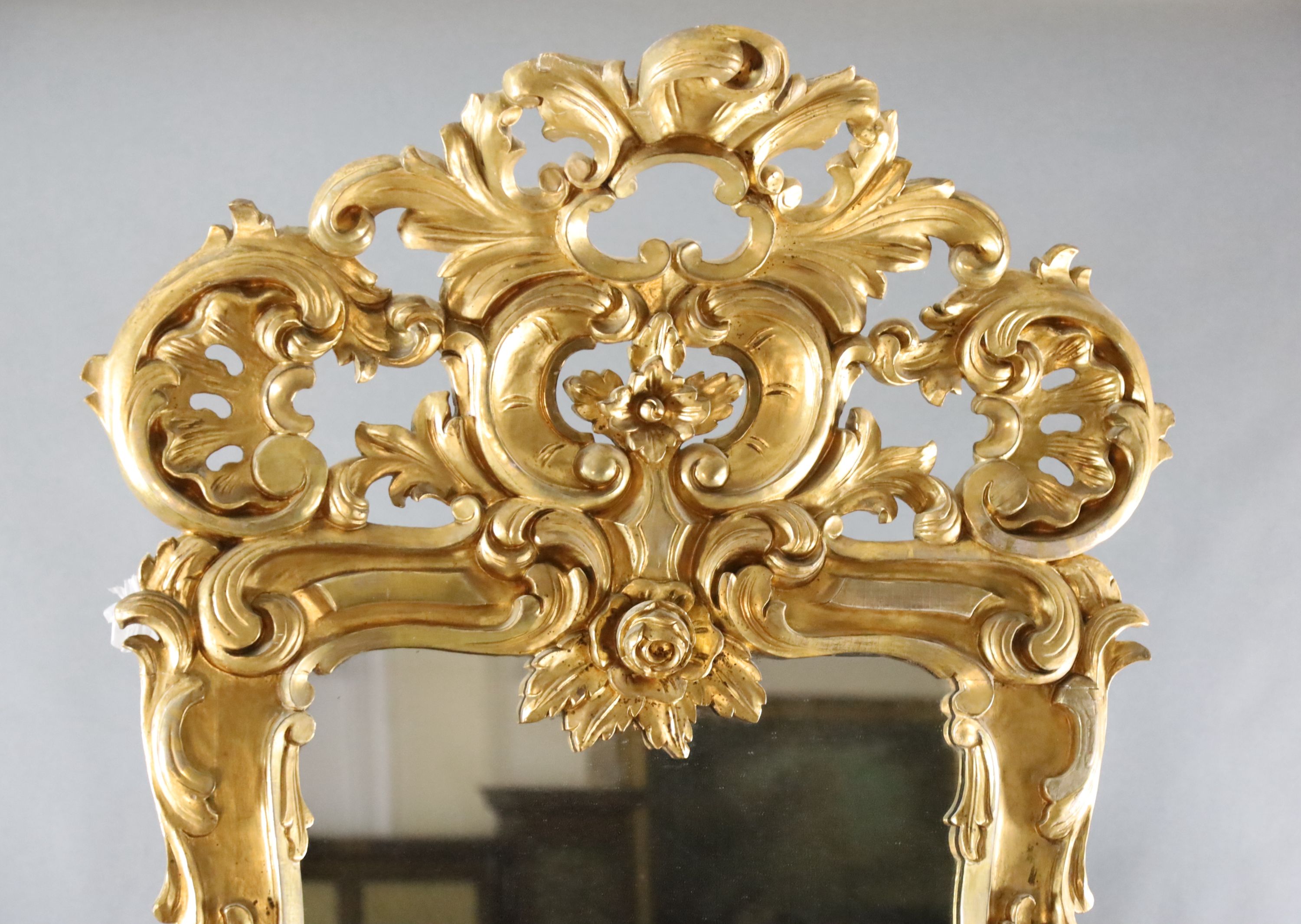 A late 19th century French carved giltwood wall mirror, W.3ft 3in. H.8ft 5in.